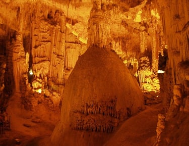 a cave with a large rock formation in the middle of it