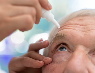 a man with a white eyeliners is getting his eyeliners
