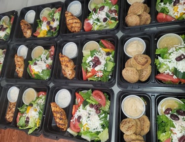 Individual meals with chicken or falafel and greek salad