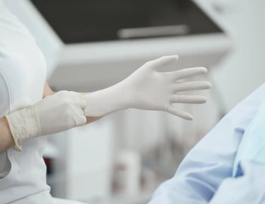 A woman wearing a pair of white gloves.