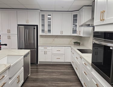 Modern kitchen with white cabinets, stainless steel appliances, and a large island.