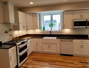 Dark granite white cabinets with cafe appliances