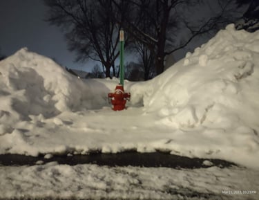 a neighborhood fire hydrant dug out of a deep Minnesota snow