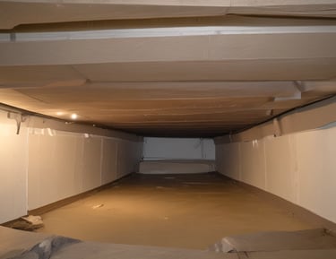 Hands typing on a laptop with a coffee cup nearby in a cozy setting.