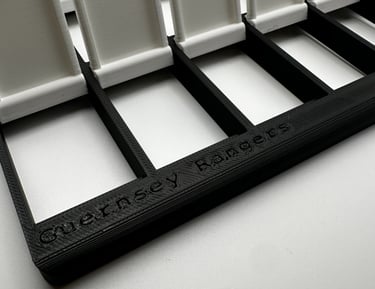 Custom 3D printed Guernsey Rangers card display stand in black and white filament.