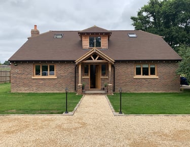 A new build chalet bungalow with oak framed windows and porch