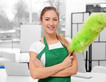 a woman in green aprons holding a green duster