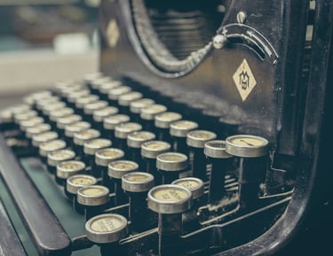 Close-up picture of an antique black typewriter's keys.
