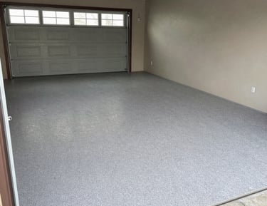 Organized garage floor with epoxy coating and neatly arranged storage racks.