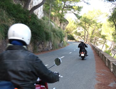Royal Enfield motorcycle riding along a beautiful road in Mallorca