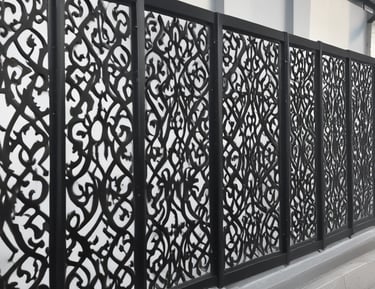 Decorative metal fences installed along a garden path, showcasing craftsmanship.