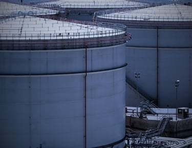 "Commercial fuel storage tanks with access platforms and industrial piping"