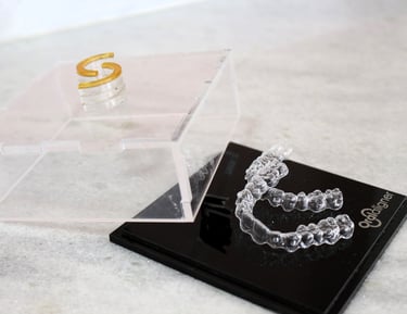 a clear plastic case with invisible teeth aligners on it