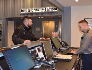 a man standing at a counter with a laptop