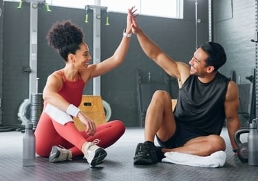 a man and woman giving high five fingers 