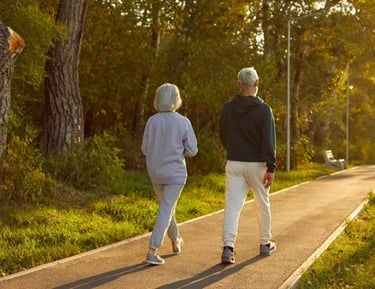 a man and woman walking down a path