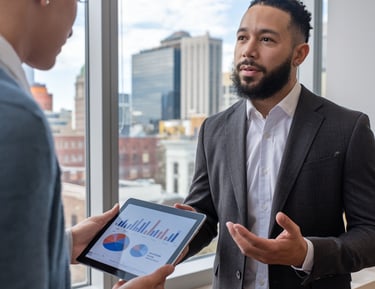 Advisor showing custom business credit plan to Albany, NY business owner with financial charts