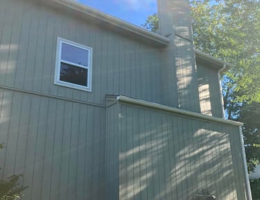 a house with a chimneypipe and a window with a window