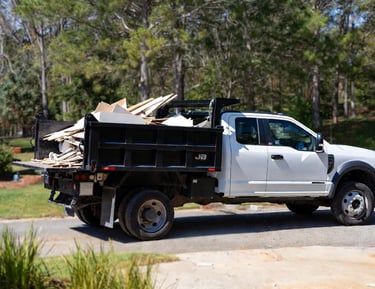 Ford F-550 dump truck hauling light construction debris and renovation waste during post-constructio