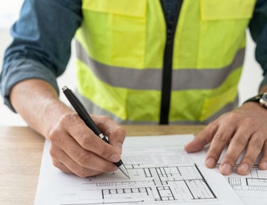 Technician inspecting modular building components in a European factory setting.