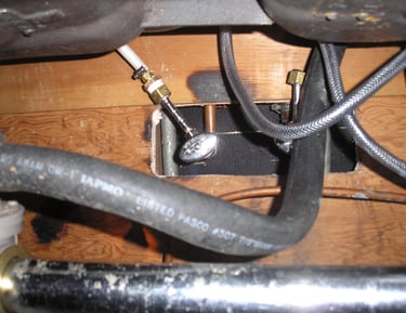 Underneath sink checking for leaks. Building maintenance.