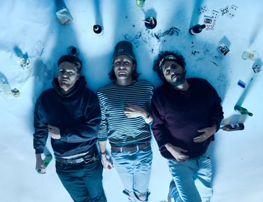 Glider band members lying on a dirty white paper.