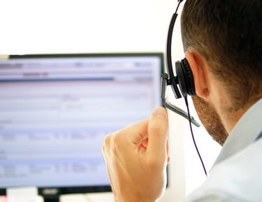 a man in a white shirt and headphones with headphones