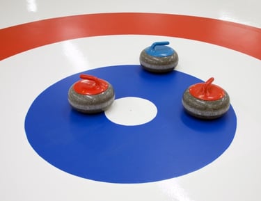 Image of curling stones on house