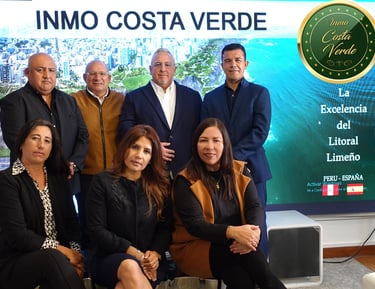 a group of people standing in front of a large screen