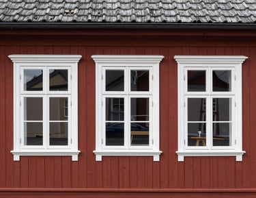 Close-up of a house facade undergoing maintenance and protective treatment.