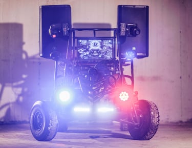 Custom off-road go-kart equipped with high-powered audio speakers and vibrant DJ party lights.