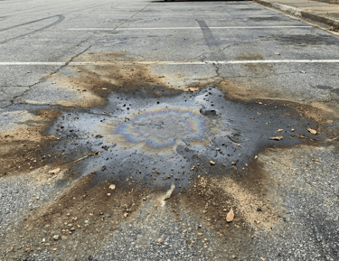 an oil stain on a parking lot