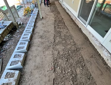 Professional contractor using a plate compactor to level crushed  rock and gravel