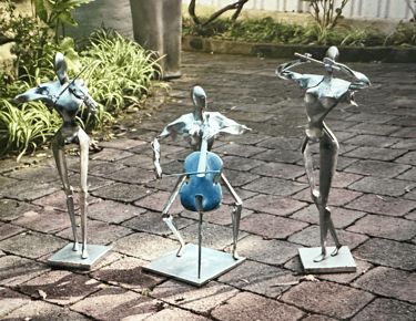 three zinc coated steel sculptures of musicians playing instruments