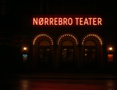 Nørrebro Teater entrance at night, inviting and slightly dramatic atmosphere