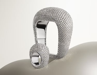 Cartier diamond-encrusted statement ring and bracelet with unique architecture.
