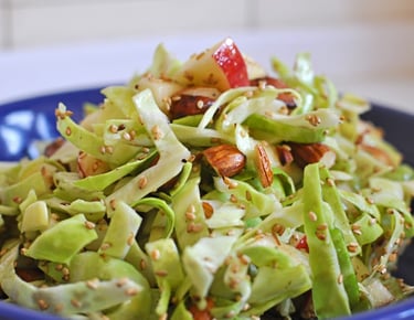 Cabbage juicy salad with apples, sesam and almonds