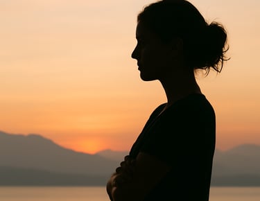A subtle silhouette of a woman with arms folded gently or standing in quiet reflection.