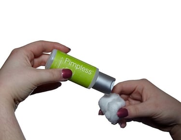 a person applying a solution on cotton balls