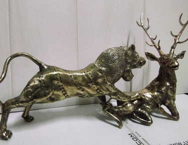 "Decorative brass piece depicting a lion chasing a deer-Globally tradable"