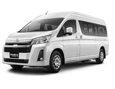 Toyota Hiace Premio warna putih dengan pintu geser velg warna silver pandangan dari kiri depan.