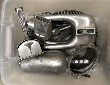 Metal parts in a sculptor's workshop bin, image 11.