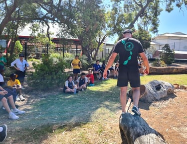 a man standing on a log in a park coaching