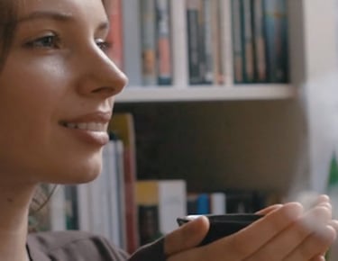 a woman holding a tea in her hand