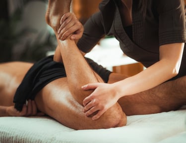 a man is getting a sports massage from a female massage therapist