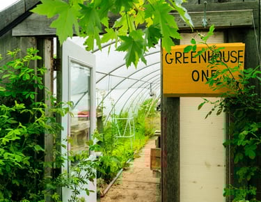 a greenhouse with a sign that says green house one