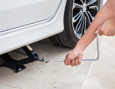 a person lifting jack with handle