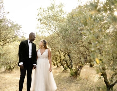 Provence elopement couple in olive grove sharing a romantic gaze, captured by fine art photographer