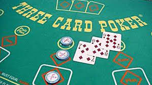 Three card poker table with winning hand