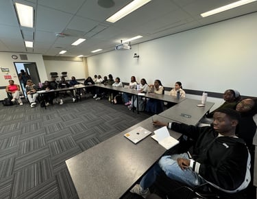 a group of youth sitting at tables in a room